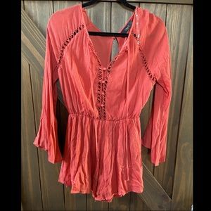 Brand new boutique purchased long sleeve romper. Gorgeous rad with cutout detail